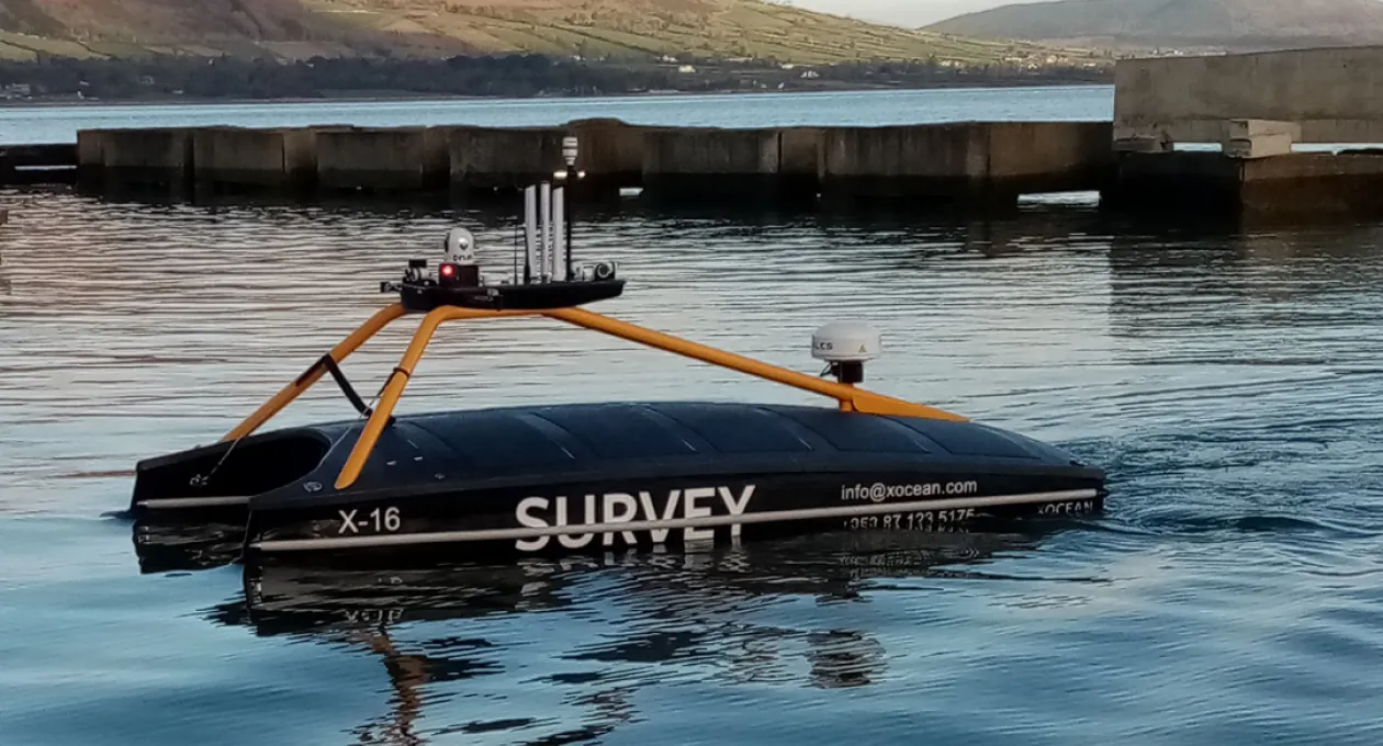 X16 Launch vessel in water with mountains in background