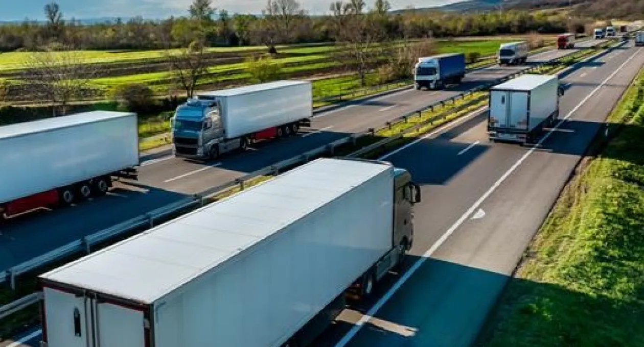 A picture of freight trucks on a road