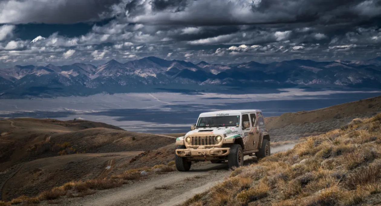 Picture of white jeep driving in desert terrain