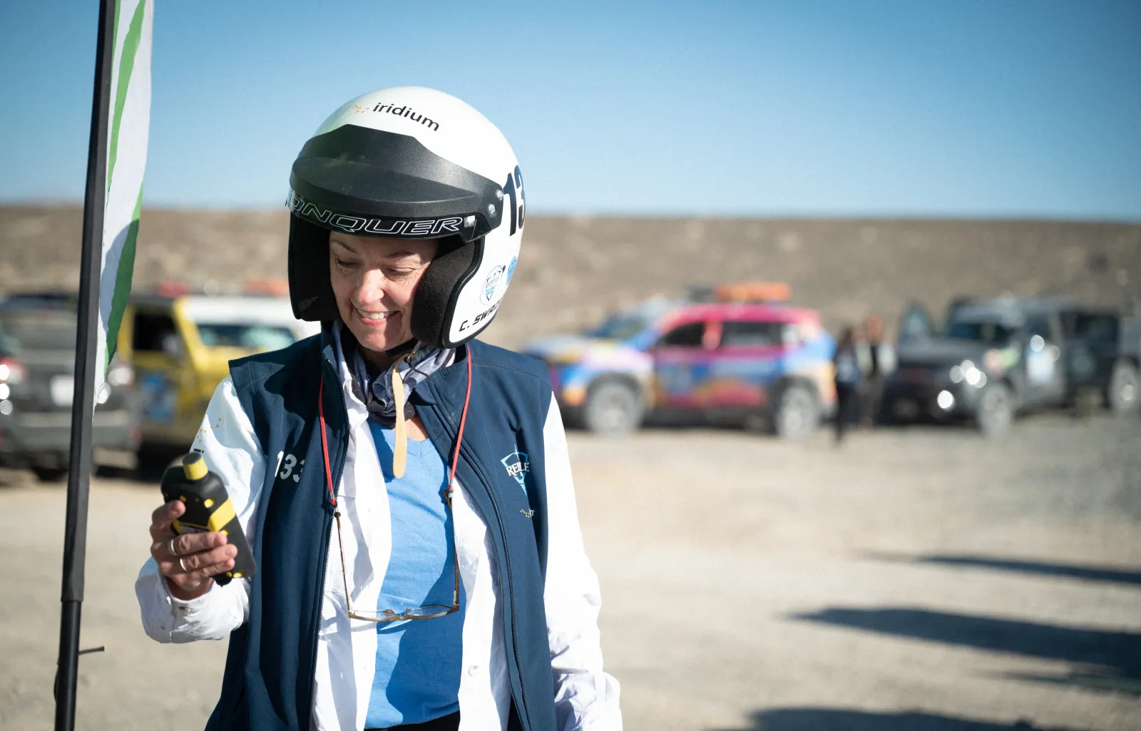 A photo of a person using a device in the desert