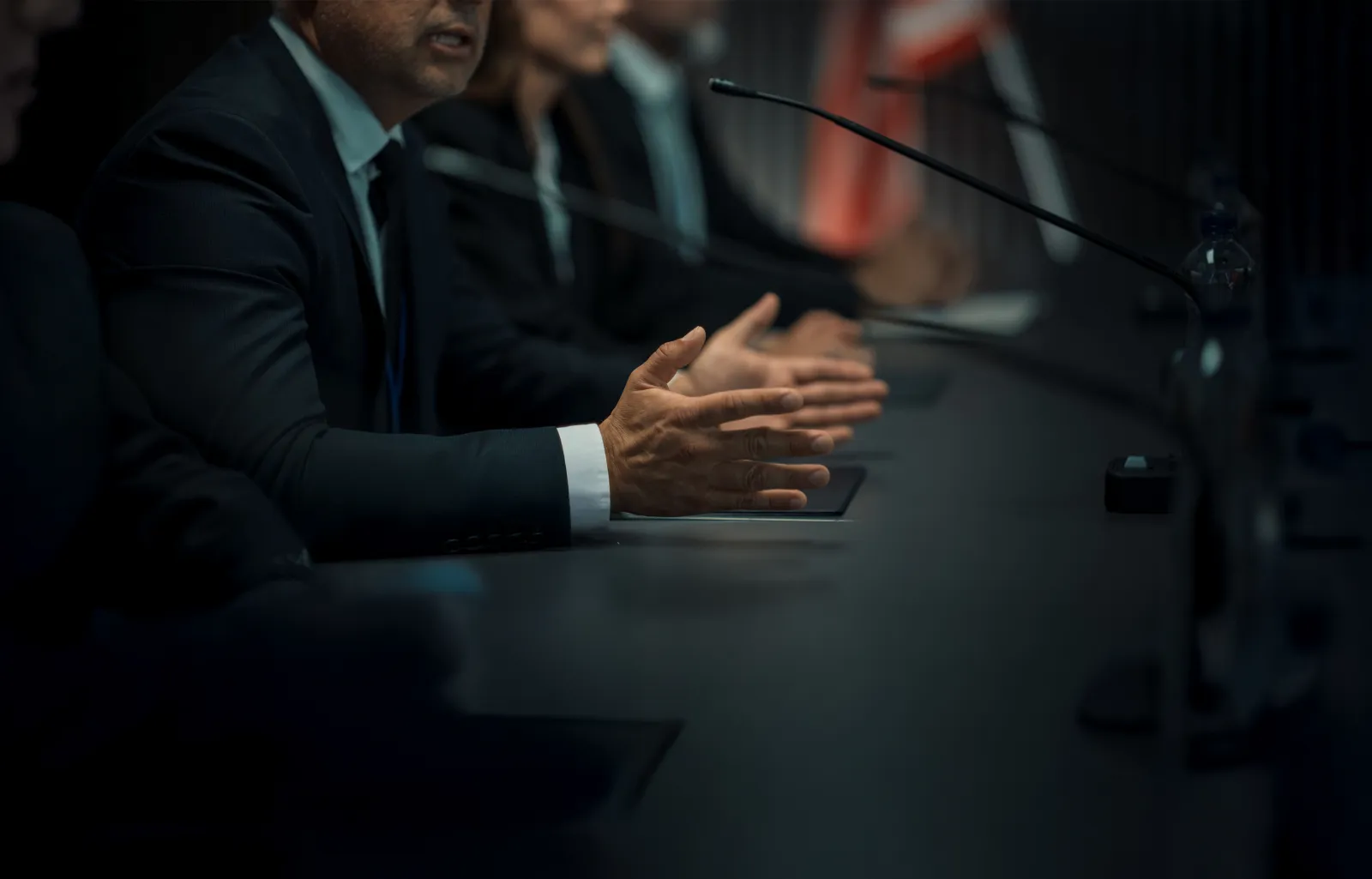 Close Up On Hands of Caucasian Male Organization Representative Speaking at Economic Conference. Head Of USA Delegation Delivering Speech at International Political Summit. Diverse Delegates Listening