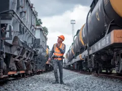 Engineer under inspection and checking construction process railway switch and checking work on railroad station .Engineer wearing safety uniform and safety helmet in work.