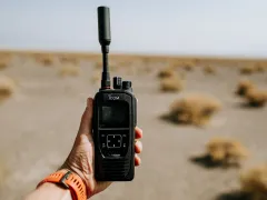 A hand holding a device