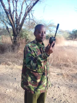 Person holding a satellite phone in hand outside in sahara