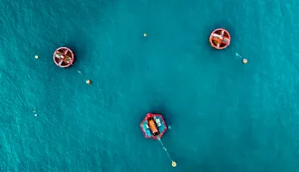 Aerial view of Blue Sea surface with red buoys