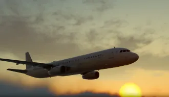 Plane over setting sun