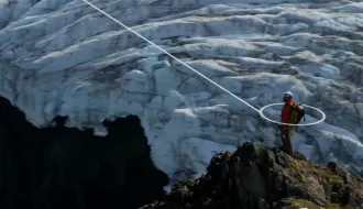 Person standing on a mountain - connecting a satellite phone to a satellite