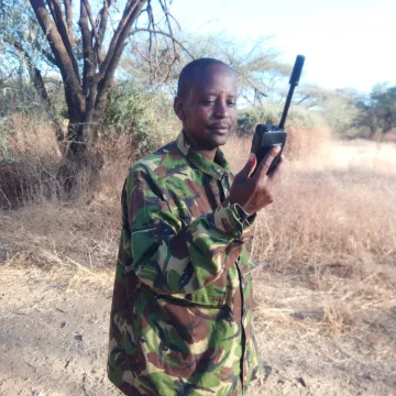 Person holding a satellite phone in hand outside in sahara