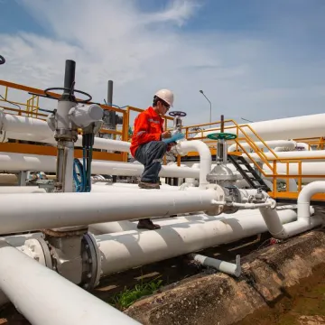 Field worker assessing gas pipeline