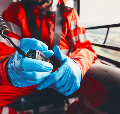 Alarm for helicopter emergency medical service. Doctor holding radio. Theme rescue, help and hope.