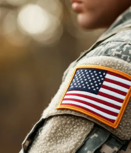 Marching soldiers with the American flag at dawn. A tribute to Veterans Day.