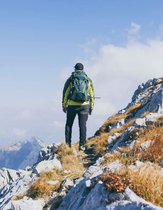 Happy hiker winning reaching life goal, success, freedom and happiness, achievement in mountains.