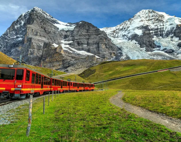 Red train travel through mountians