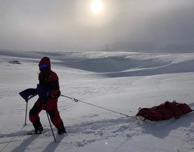 Person trekking through the south pole - pulling a sled of equiptment