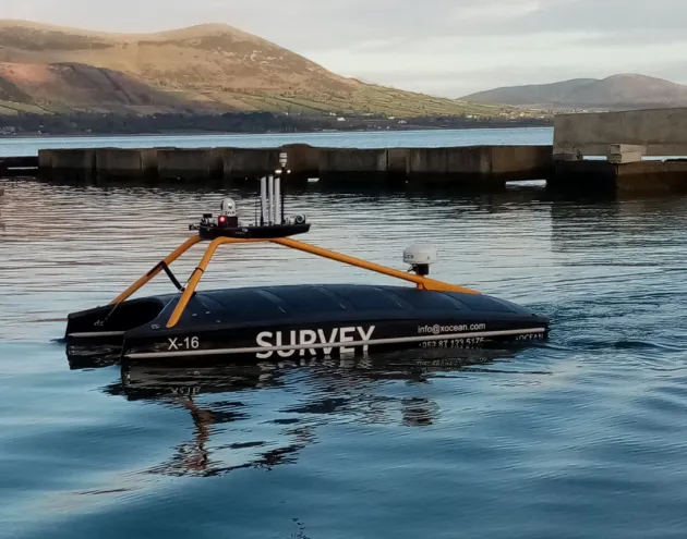 X16 Launch vessel in water with mountains in background