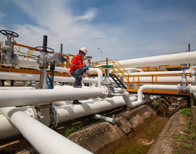 Male worker inspection at valve of visual check record pipeline oil and gas industry