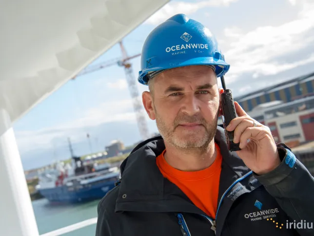 A worker calling on Iridium Extreme 