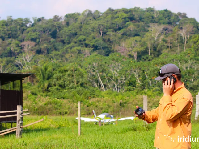A man using Iridium Go! in a forested area