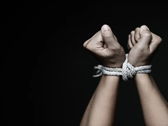 Hands tied with a rope, symbolizing modern slavery and human rights