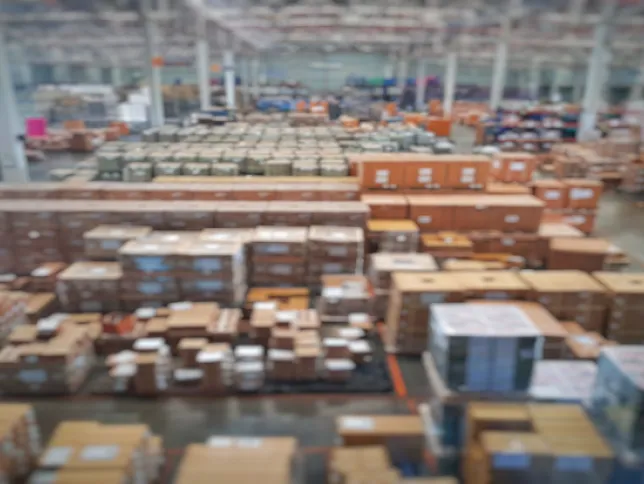 Interior of a warehouse facility with numerous stacked boxes