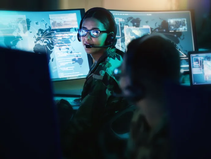 Military control room, headset and woman with man, computer and tech for communication. Security, global surveillance and soldier with teamwork in army office at government cyber data command center