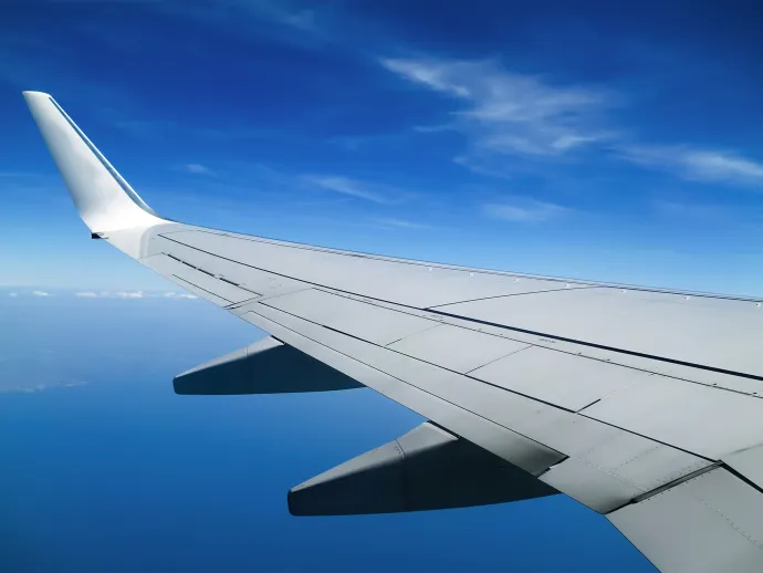 View of a plane wing in blue skies