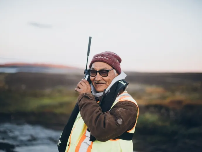 Man holding Iridium phone to his ear