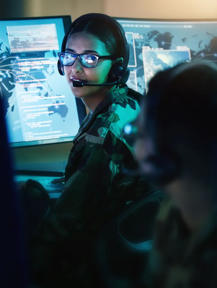 Military control room, headset and woman with man, computer and tech for communication. Security, global surveillance and soldier with teamwork in army office at government cyber data command center