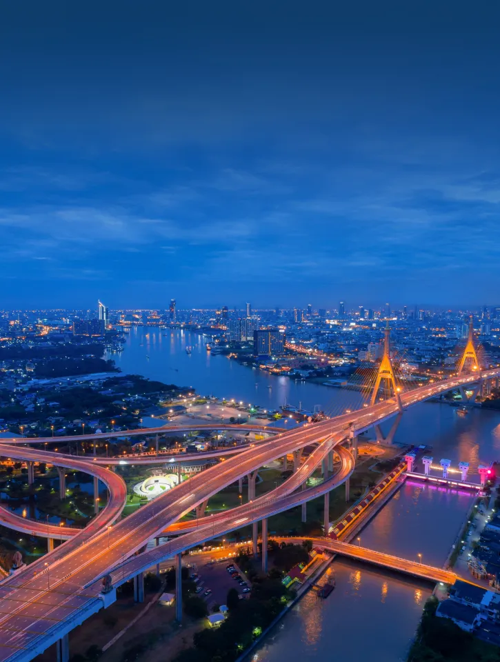 Top view over the highway,expressway and motorway at night, Aerial view interchange of a city, Shot from drone,Expressway is an important infrastructure in Thailand