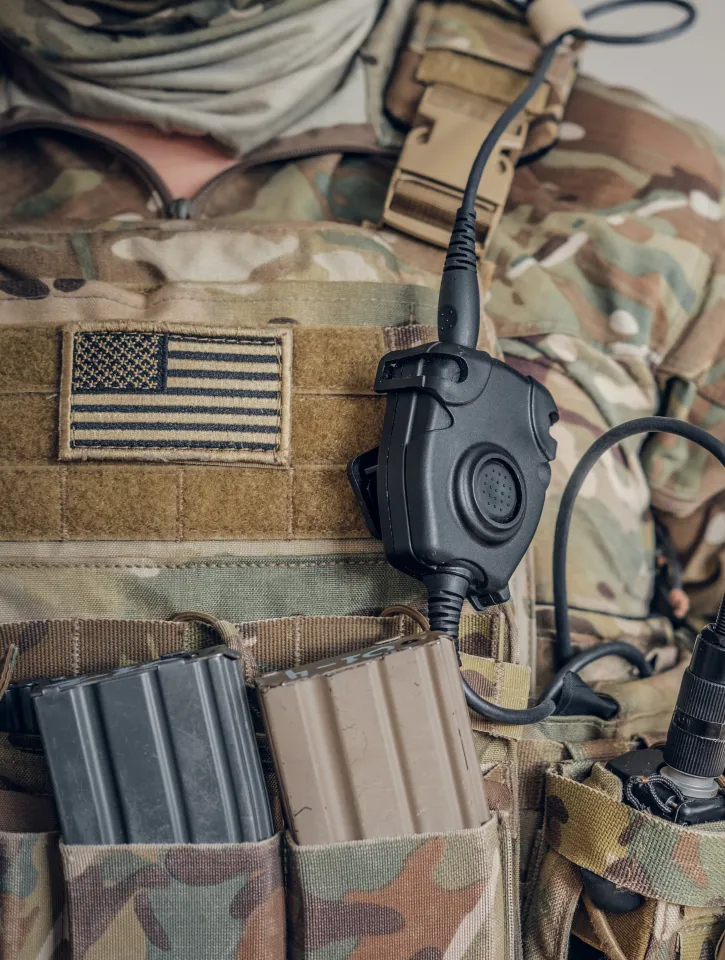 Closeup photo shoot of military man in USA army uniform with radio in his pocket.