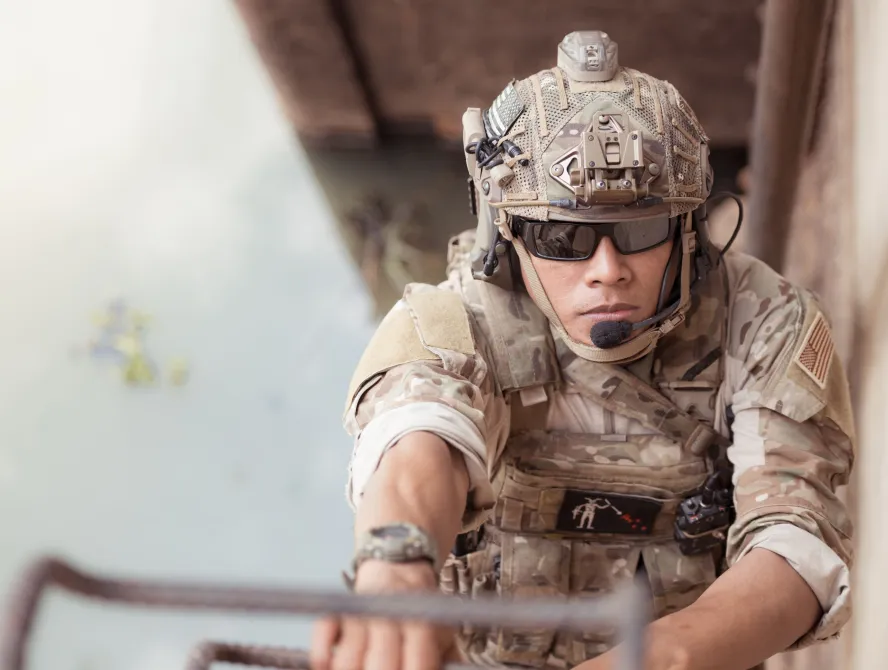 Soldiers in camouflage military uniforms carrying weapons, Reconnaissance missions in the tropical forest area with hiding and camouflaging the enemy