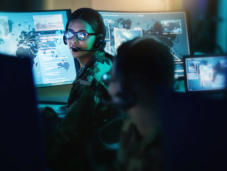 Military control room, headset and woman with man, computer and tech for communication. Security, global surveillance and soldier with teamwork in army office at government cyber data command center
