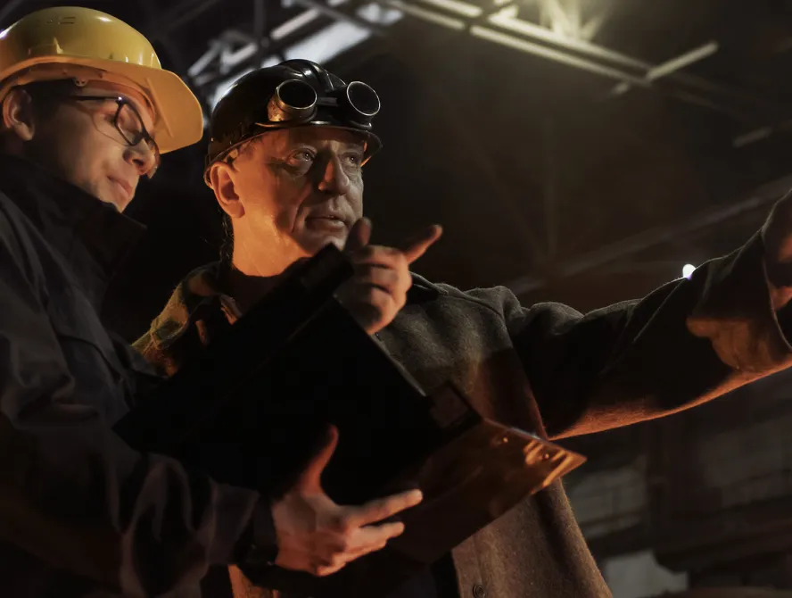 Site engineers are having a conversation in an underground mine