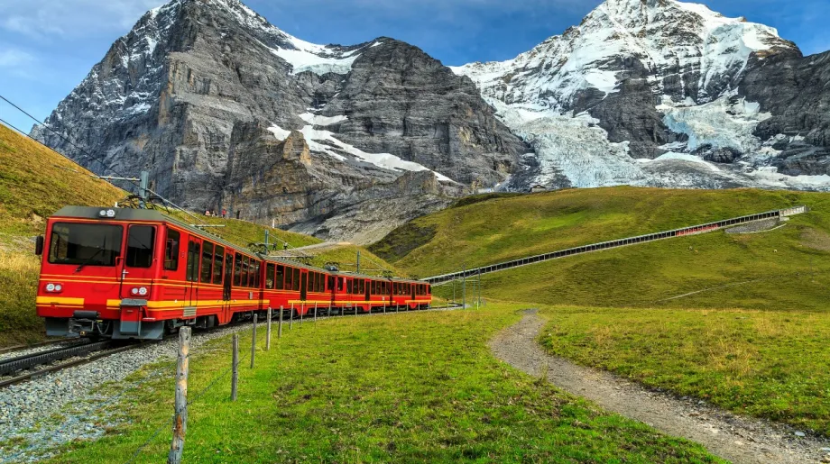 Red train travel through mountians