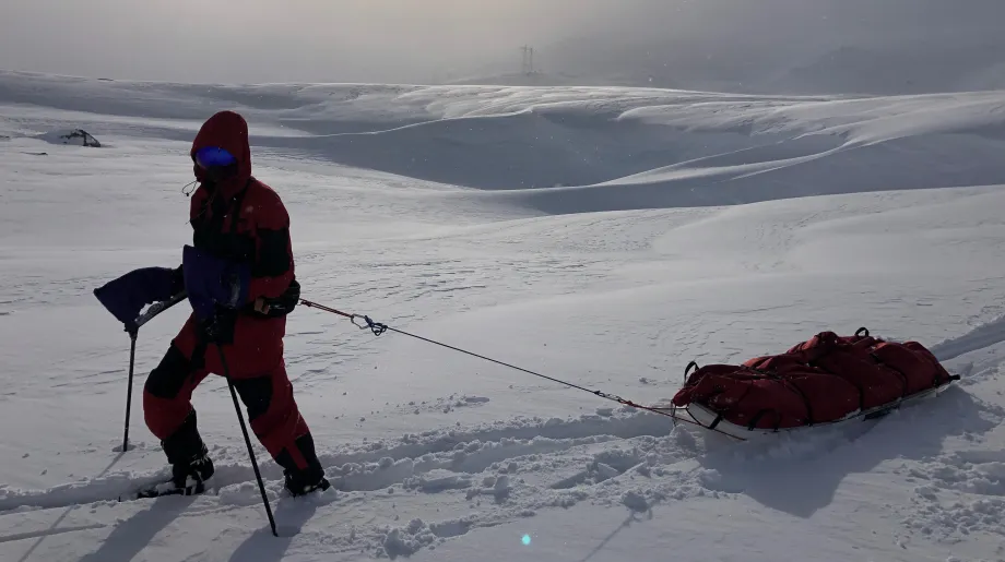 Person trekking through the south pole - pulling a sled of equiptment