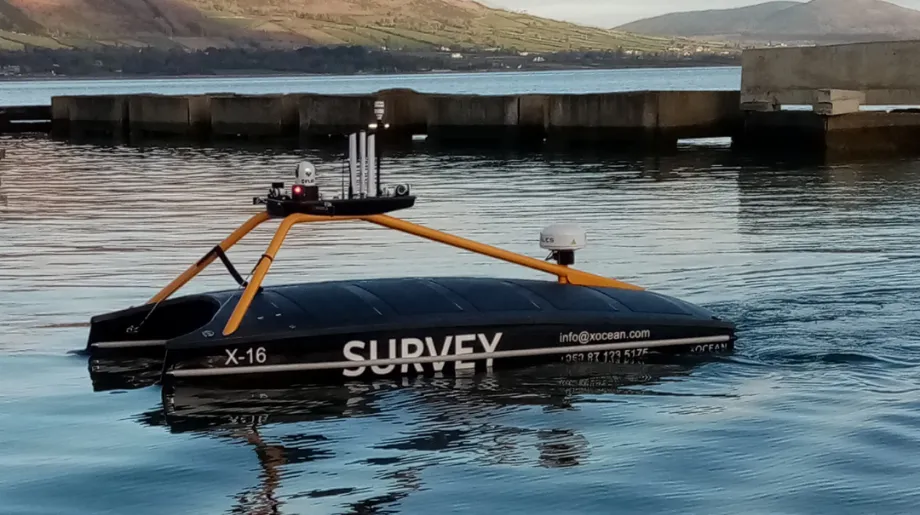X16 Launch vessel in water with mountains in background