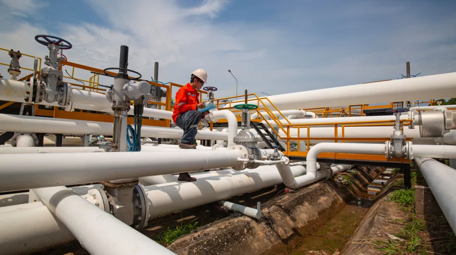 Male worker inspection at valve of visual check record pipeline oil and gas industry