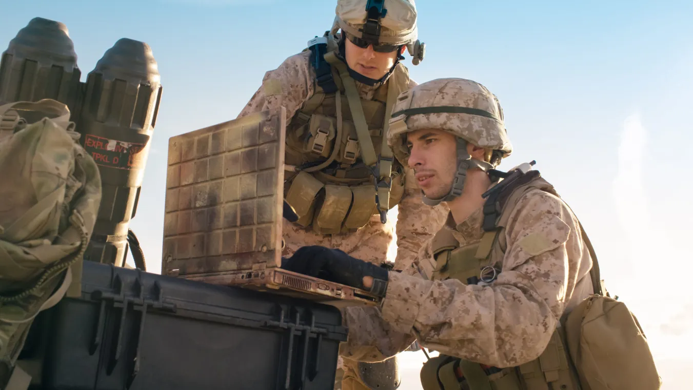 Soldiers are Using Laptop Computer for Surveillance During Military Operation in the Desert.