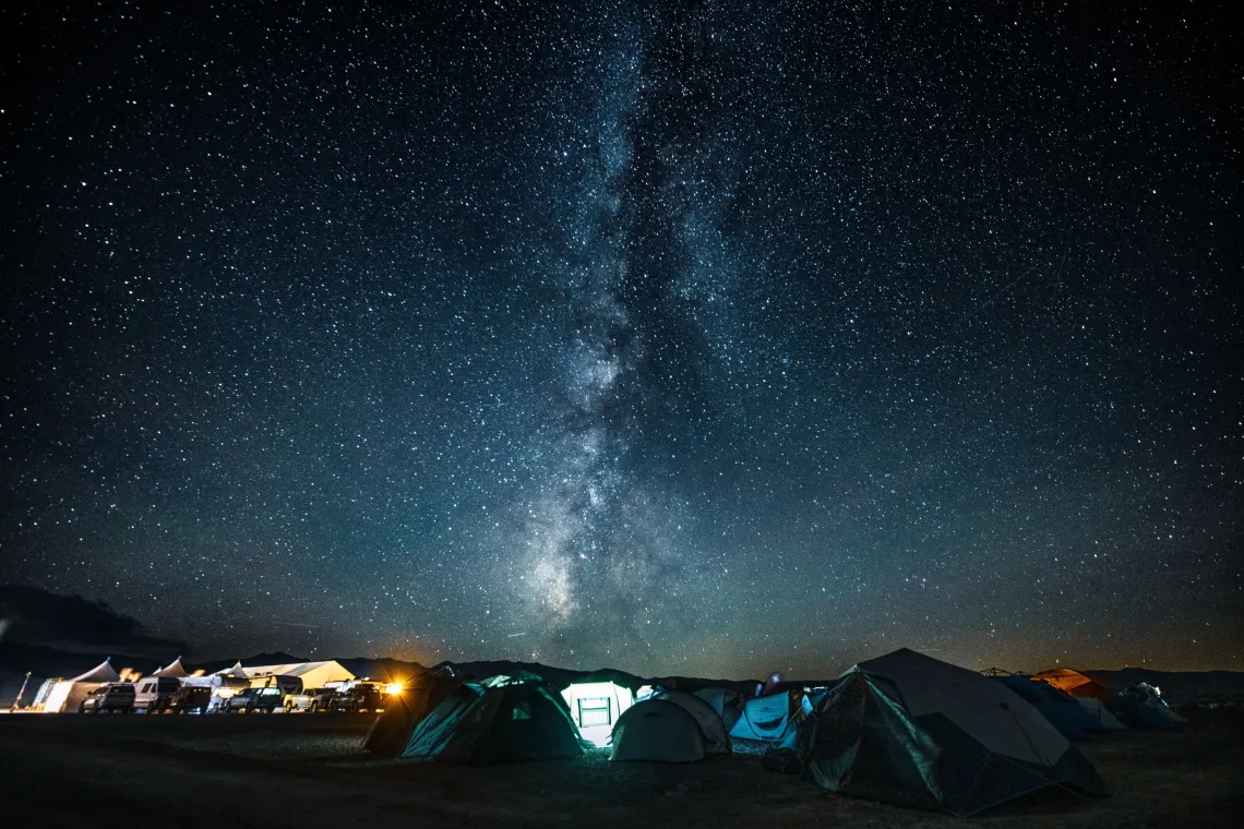 Picture of campsite with tents under star lit night sky
