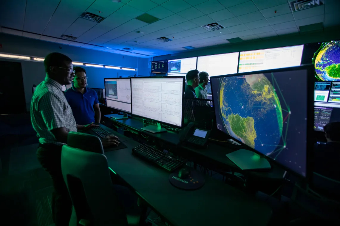 Employees discussing work at Iridium.