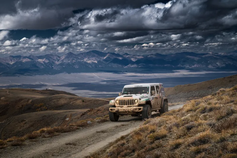 Picture of white jeep driving in desert terrain