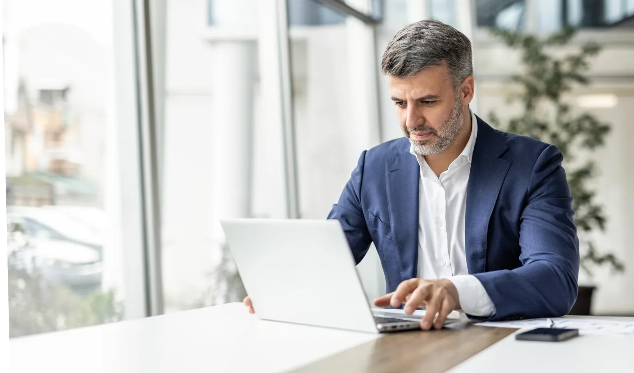 A man is checking his emails on the laptop