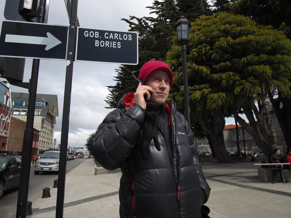 Man holding Iridium phone to his ear