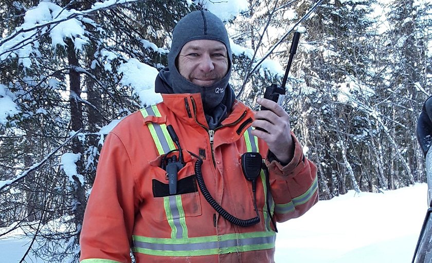 utility worker holding ptt device