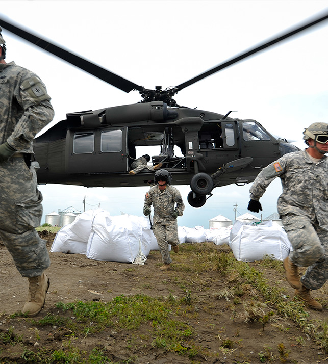 U.S. army soldiers deplaning from a helicopter