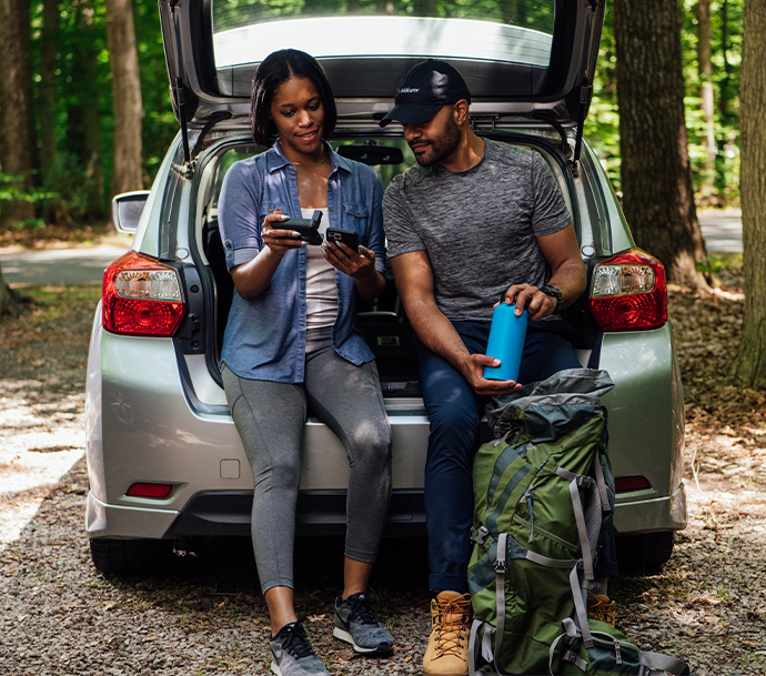 Couple using Iridium GO! after a hike