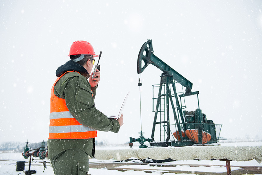 Industrial worker uses Iridium Extreme PTT near oil rig