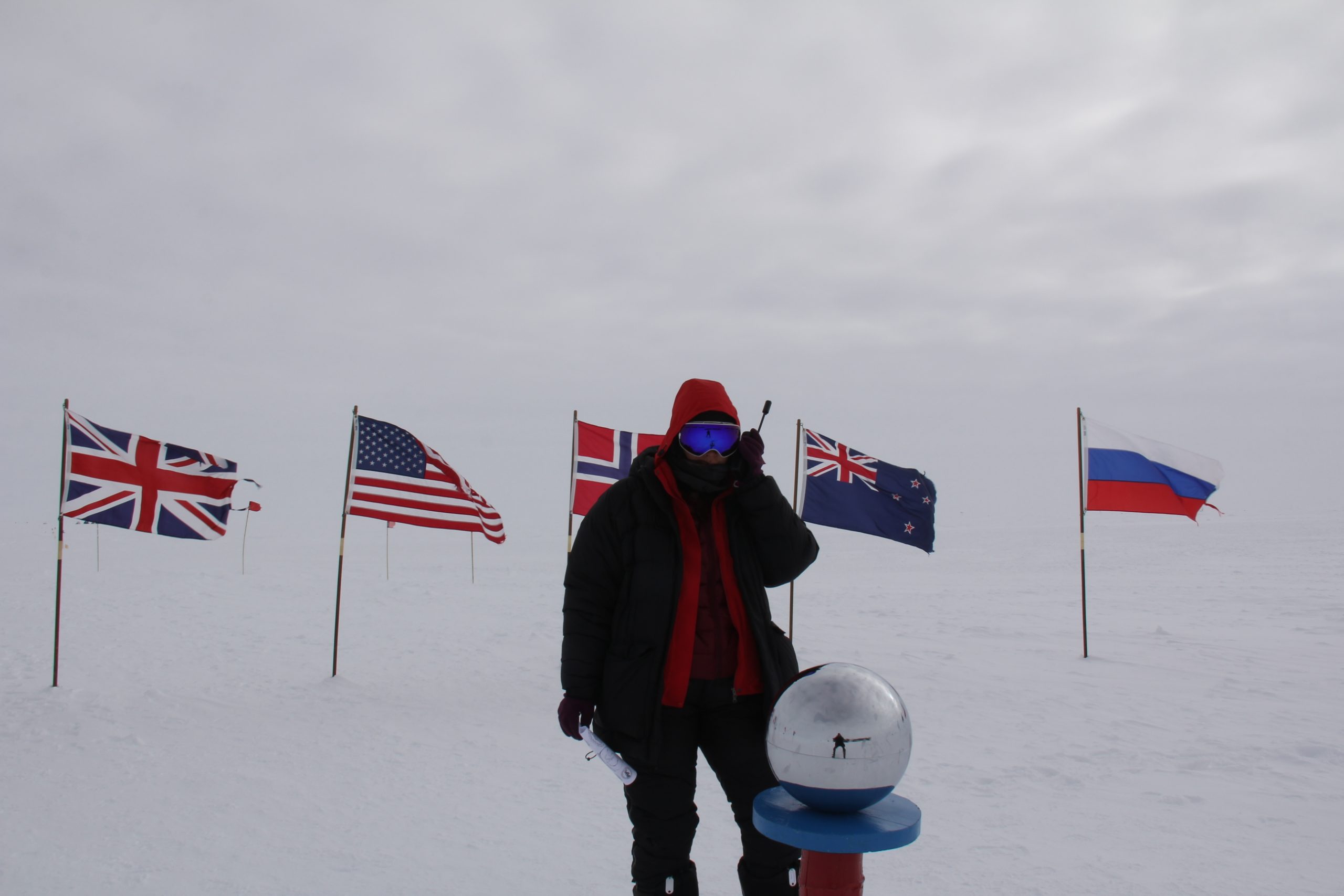 A polar explorer using the Iridium 9555 satellite phone at the South Pole.